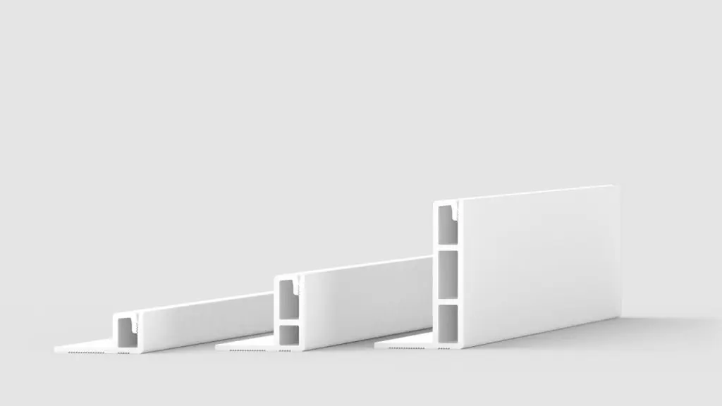 Three white, rectangular plastic profiles with hollow sections are shown standing upright on a reflective surface, positioned side by side, with increasing height from left to right