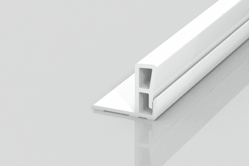 A white, rectangular plastic or metal profile with two hollow sections sits on a reflective surface. One side has a flat extension with a textured edge, suggesting use as a trim or connector piece.