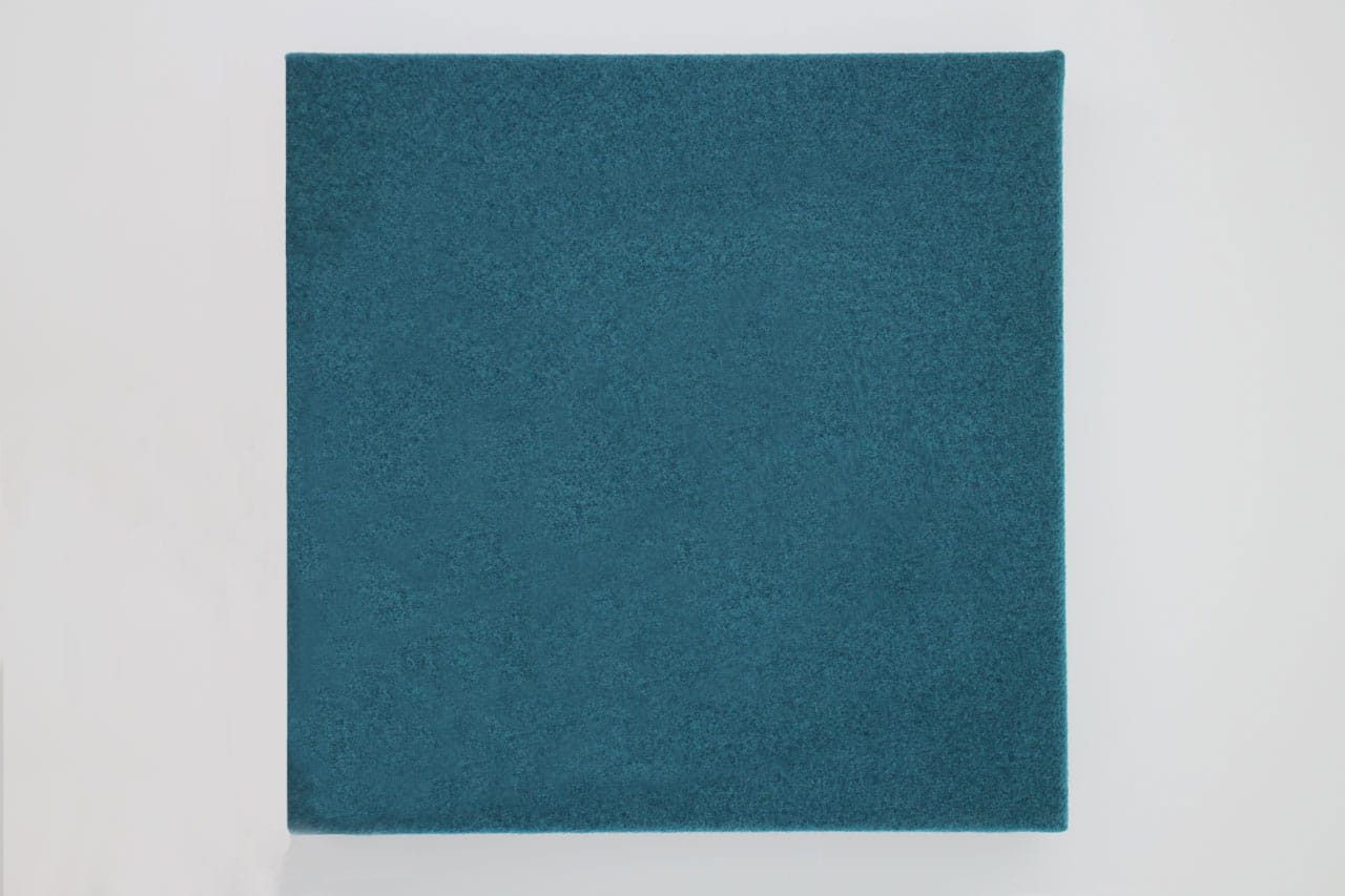 A blue textured square panel, part of the Fabrix™ Acoustic System Warranty, is centered against a white background. The surface appears evenly colored and slightly rough, with clean, sharp edges.