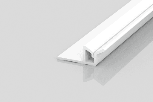 A white plastic T-shaped trim piece with a grooved base and flat flange, placed on a smooth, reflective surface against a light gray background.